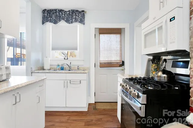 a kitchen with stainless steel appliances a stove and a refrigerator