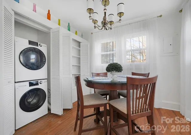 a view of a dining room with furniture a rug and wooden floor