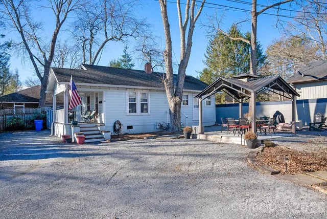 a view of a house with small yard and sitting area