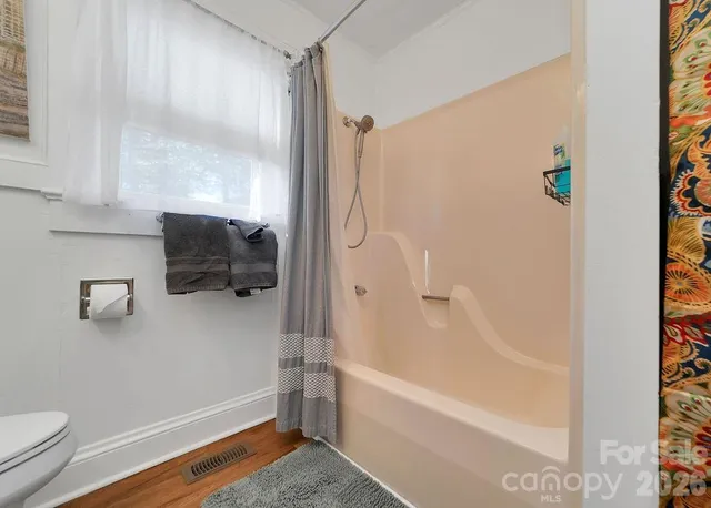 a bathroom with a tub and a shower
