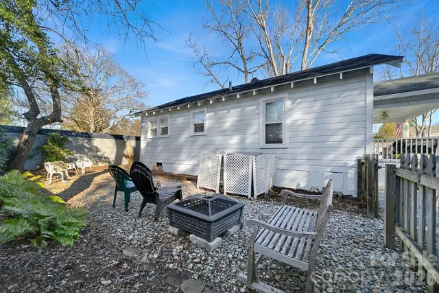 a backyard of a house with table and chairs