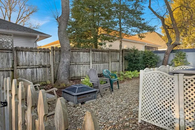 a view of a chairs and table in backyard