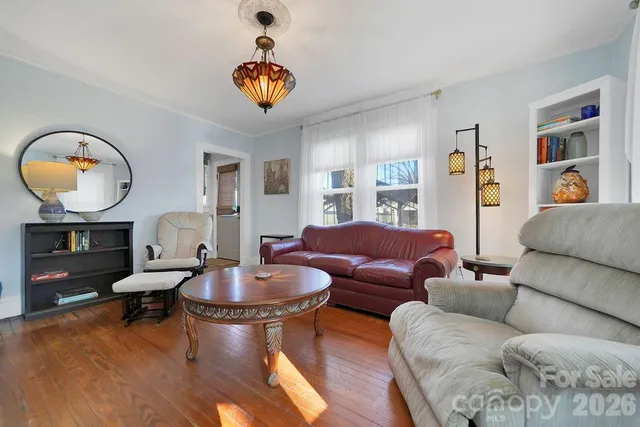 a living room with furniture a rug and a large window