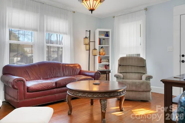 a living room with furniture and a lamp