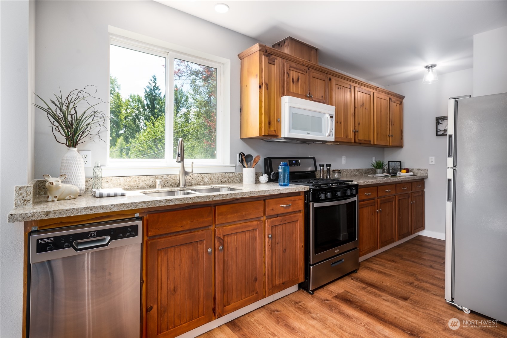 5701 Lerch Road Snohomish, WA 98290 - Photo 11 of 34 a kitchen with stainless steel appliances granite countertop a sink a stove and a refrigerator