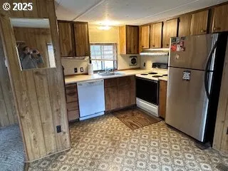 a kitchen with stainless steel appliances granite countertop a refrigerator and a sink