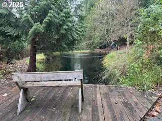 a view of a wooden bench next to a lake