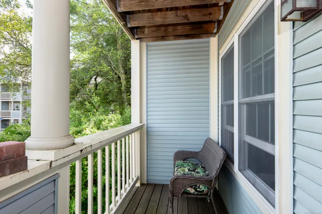 a view of balcony with furniture and wooden floor