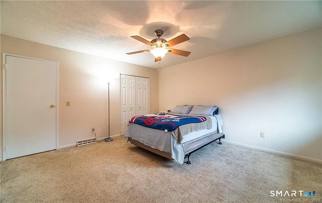 5 Stonegate Circle, Unit F Branford, CT 06405 - Photo 7 of 15 a bedroom with a bed and a ceiling fan