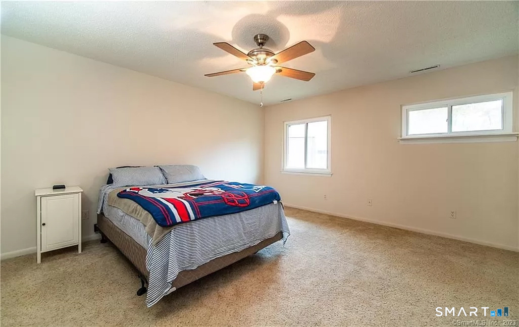 5 Stonegate Circle, Unit F Branford, CT 06405 - Photo 8 of 15 a living room with a bed and window