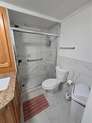a bathroom with a toilet and a shower