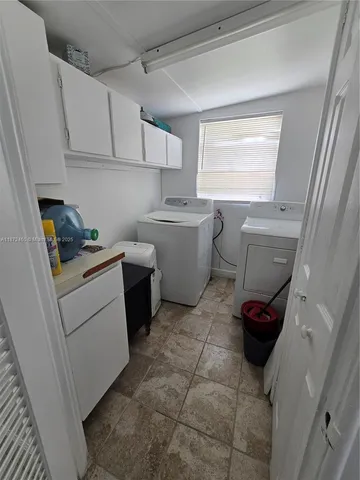 a kitchen with a sink cabinets and a window