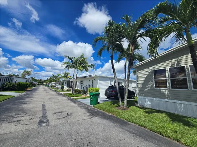 a view of a house with a yard and a garden