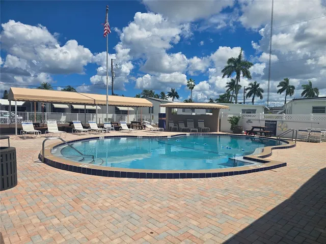 a view of a swimming pool with a yard