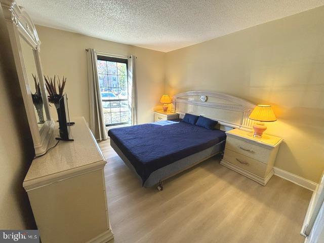 27 Gilpin Court Lawrence Township, NJ 08648 - Photo 12 of 20 a spacious bedroom with a bed and wooden floor