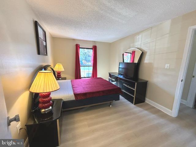 27 Gilpin Court Lawrence Township, NJ 08648 - Photo 13 of 20 a bedroom with a bed and a flat screen tv