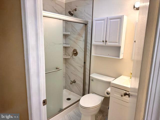 27 Gilpin Court Lawrence Township, NJ 08648 - Photo 16 of 20 a bathroom with a granite countertop toilet sink and shower