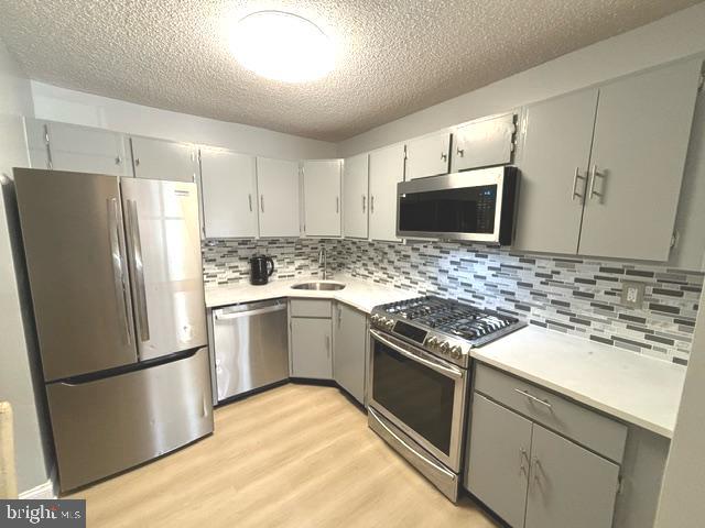 27 Gilpin Court Lawrence Township, NJ 08648 - Photo 4 of 20 a kitchen with a refrigerator sink and microwave