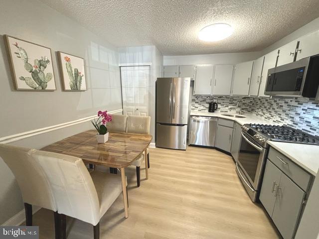 27 Gilpin Court Lawrence Township, NJ 08648 - Photo 8 of 20 a kitchen with stainless steel appliances granite countertop a sink refrigerator and microwave