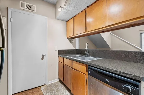 a kitchen with a sink cabinets and appliances
