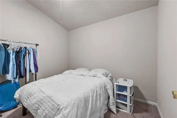 a bed sitting in a bedroom next to a window