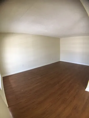 an empty room with wooden floor