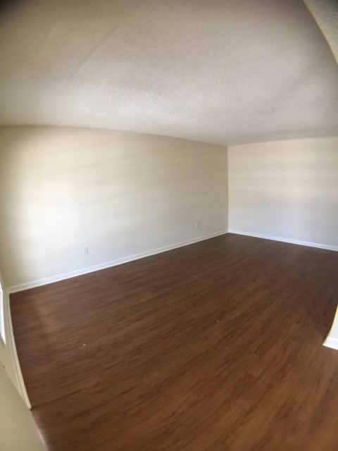 4709 Harmon Avenue, Unit 416 Austin, TX 78751 - Photo 3 of 8 an empty room with wooden floor