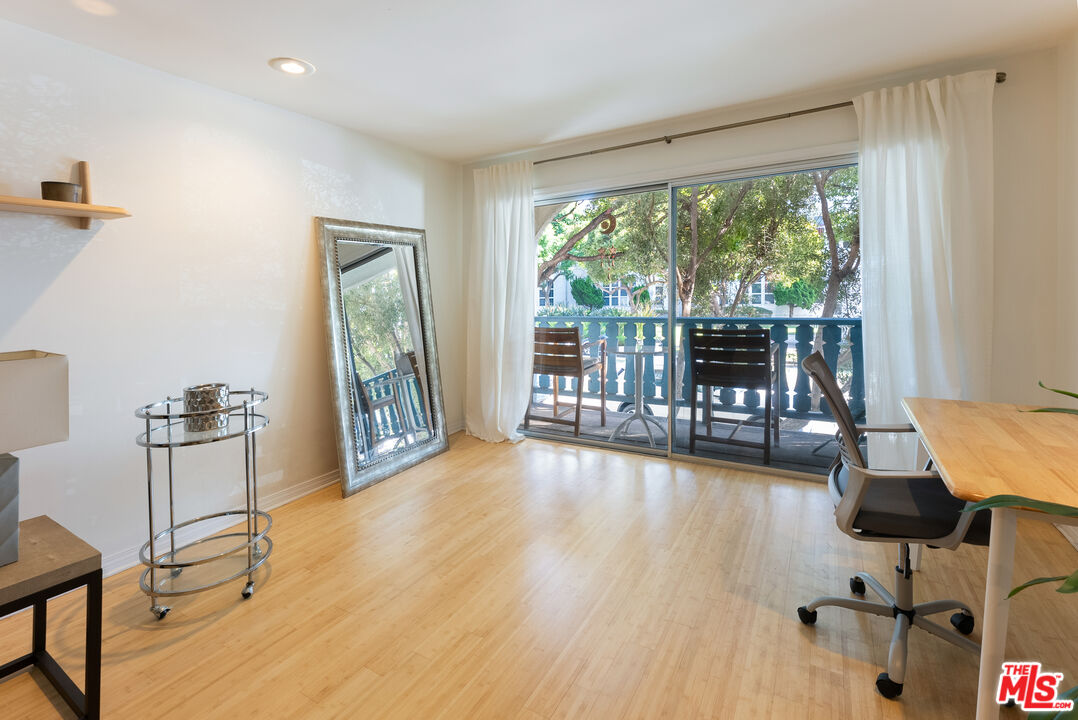 1255 10th Street, Unit 106 Santa Monica, CA 90401 - Photo 4 of 15 a living room with furniture and a large window