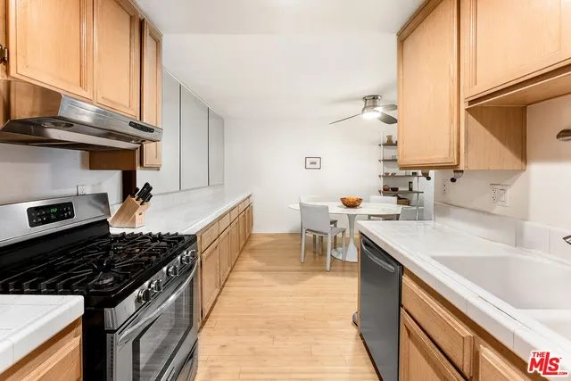 a kitchen with a sink stove top oven and cabinets