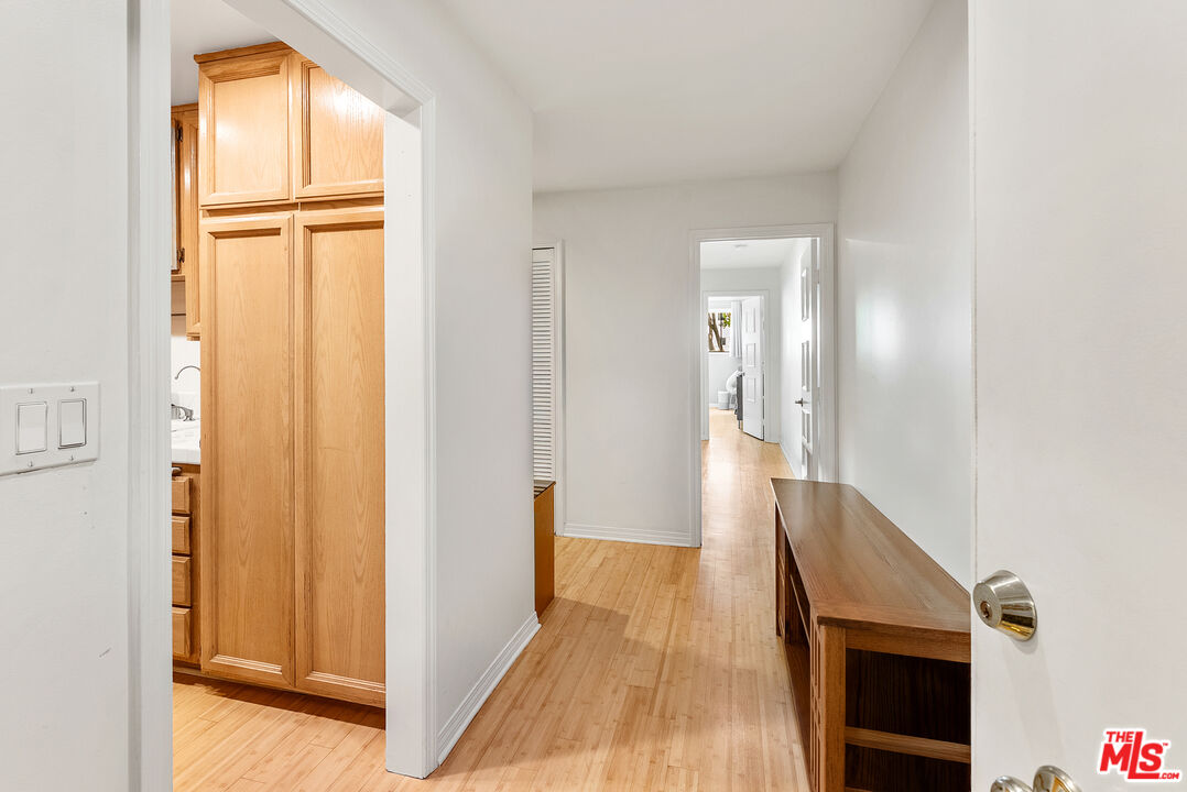 1255 10th Street, Unit 106 Santa Monica, CA 90401 - Photo 7 of 15 a view of a hallway with wooden floor and staircase