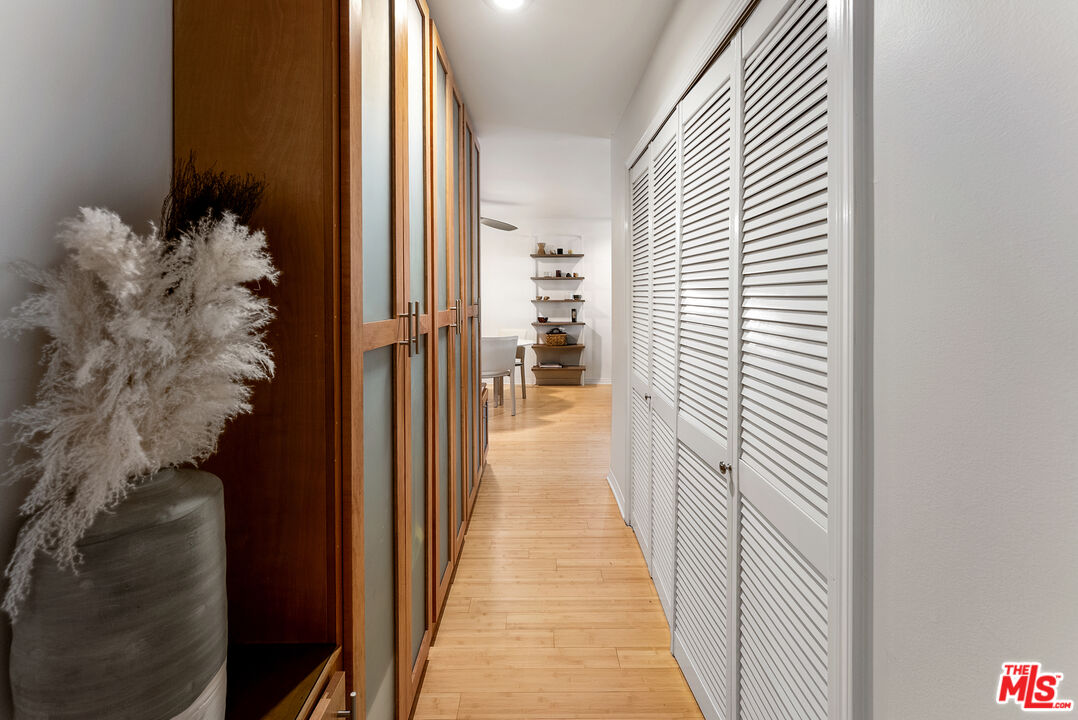 1255 10th Street, Unit 106 Santa Monica, CA 90401 - Photo 8 of 15 a view of a hallway with wooden floor and a potted plant