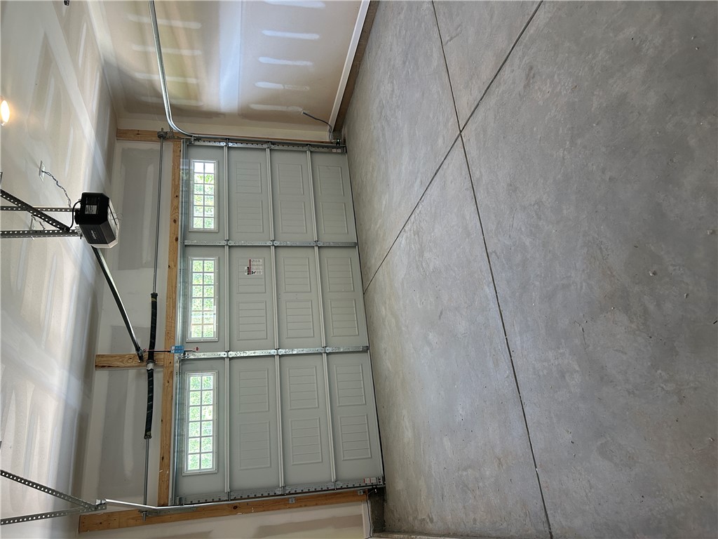 211 Bellflower Lane Anderson, SC 29625 - Photo 25 of 28 A spacious garage featuring a functional garage door opener and durable concrete flooring.