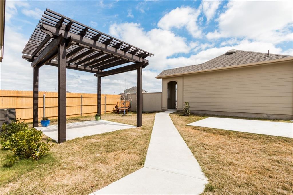 2104 Pindos Pony Way Georgetown, TX 78626 - Photo 29 of 30 Relax under the inviting pergola on this spacious concrete patio, perfect for outdoor enjoyment.