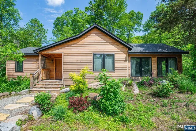 a view of a house with backyard and a tree