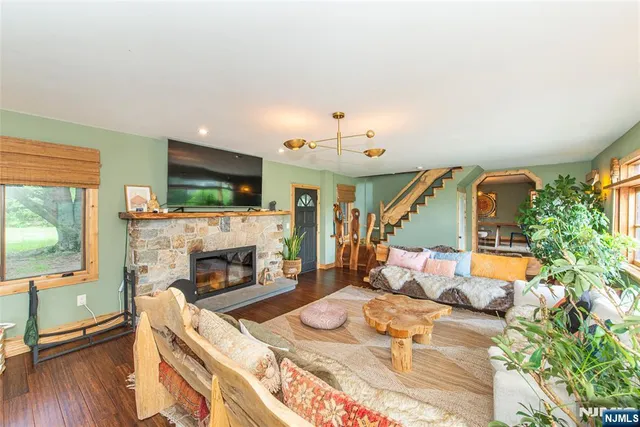 a living room with furniture a rug and a table