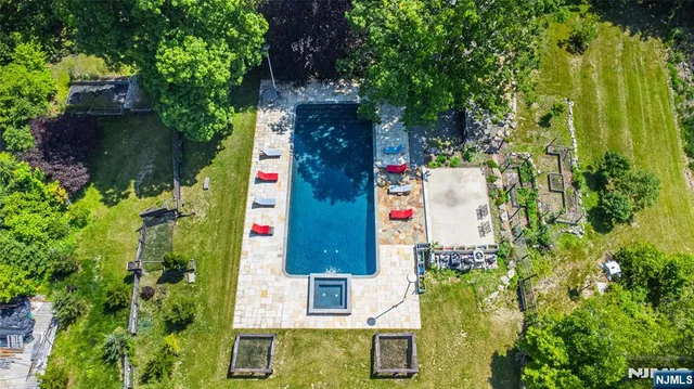 an aerial view of residential house with outdoor space and trees
