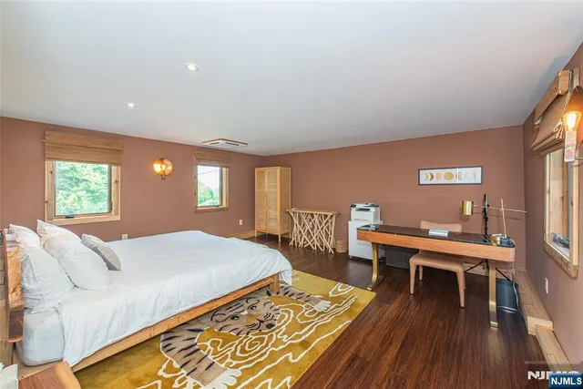 an aerial view of residential house with outdoor space and trees all around