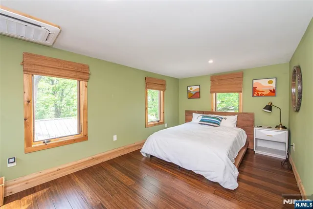 a view of a lush green forest with trees and some houses