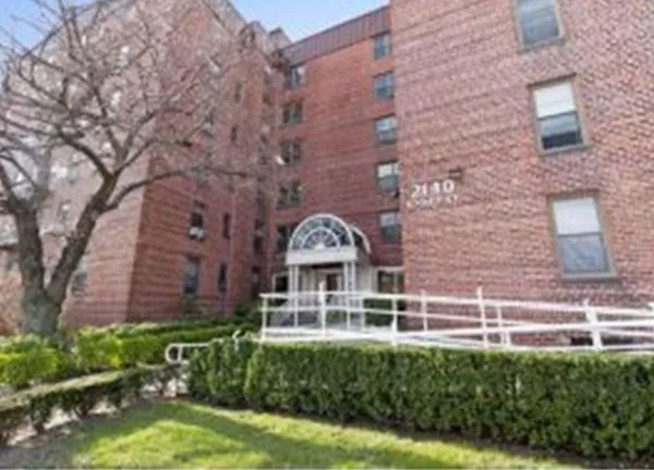 front view of a building with a garden