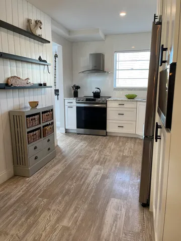 a kitchen with stainless steel appliances a stove and a refrigerator