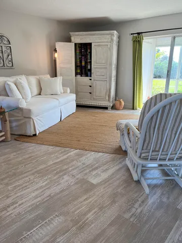 a living room with furniture and large window