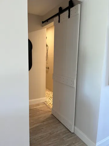 a view of walk in closet with wooden floor