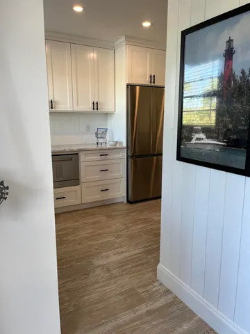 a kitchen with granite countertop a refrigerator and a stove