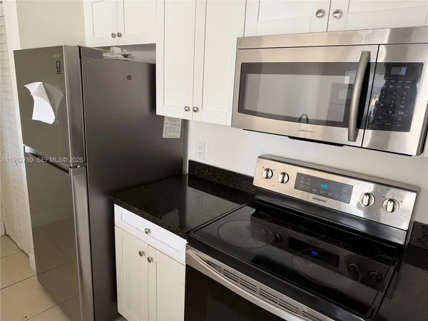 a stove top oven sitting inside of a kitchen
