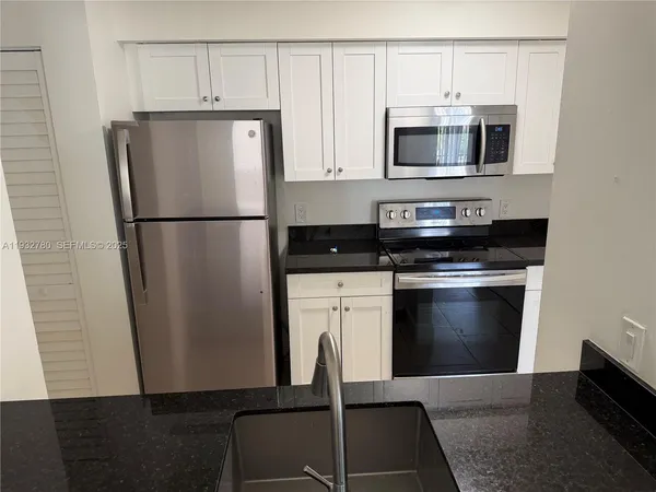 a white refrigerator freezer sitting in a kitchen