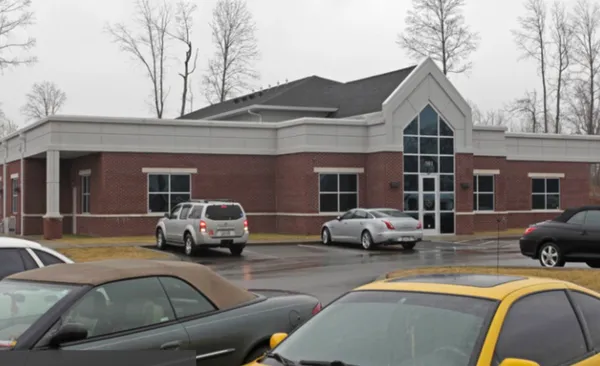 a couple of cars parked in front of a house