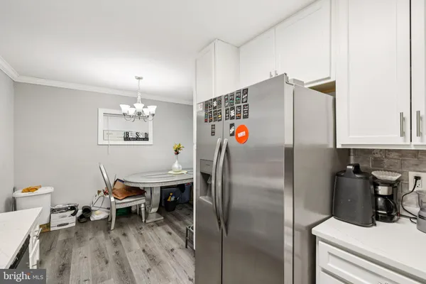 a kitchen with stainless steel appliances a refrigerator and a table