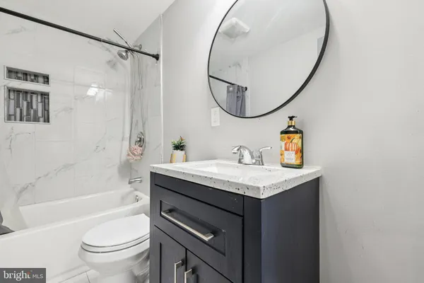 a bathroom with a sink a toilet and a mirror