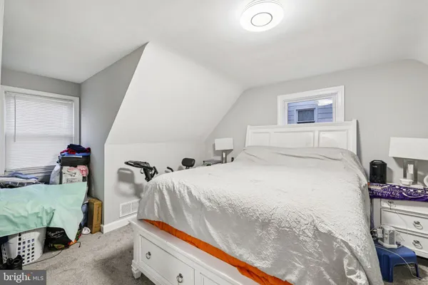 a bedroom with a bed and a mirror