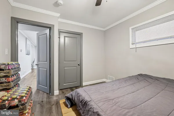 a bedroom with a bed and a wooden floor
